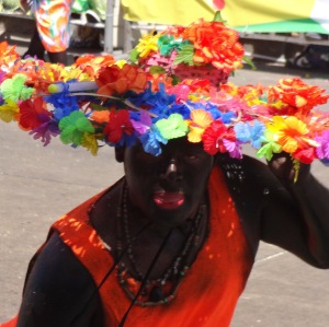 The black face paint and bright red lip paint are used for the Son de Negro costume.