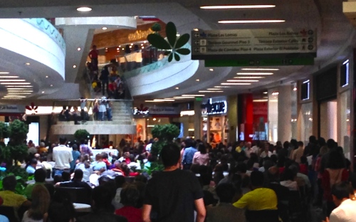 People crowding in for Sunday Mass at Santafe Mall in Medellín